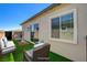 Staged backyard featuring comfortable furniture and low-maintenance artificial turf at 924 Allister Fields Ln, Las Vegas, NV 89138