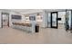 Modern bar area boasts a marble counter with seating, sleek cabinetry, and a built-in entertainment center at 924 Allister Fields Ln, Las Vegas, NV 89138