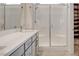 Stylish bathroom boasts double sinks, quartz counters, and a glass enclosed shower at 924 Allister Fields Ln, Las Vegas, NV 89138