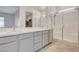 Bright bathroom features double sinks and walk-in shower with glass door at 924 Allister Fields Ln, Las Vegas, NV 89138