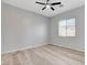 A bright bedroom featuring modern flooring and a large window at 924 Allister Fields Ln, Las Vegas, NV 89138