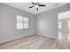 Bright and airy bedroom features new flooring and contemporary ceiling fan at 924 Allister Fields Ln, Las Vegas, NV 89138