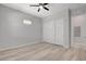 Cozy bedroom with a ceiling fan, light wood-look floors, and a closet with sliding doors at 924 Allister Fields Ln, Las Vegas, NV 89138