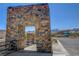 Stone architectural feature marking community entrance; mountain views beyond at 924 Allister Fields Ln, Las Vegas, NV 89138