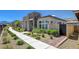 Charming home exterior with manicured landscaping, a walkway, and modern architectural details at 924 Allister Fields Ln, Las Vegas, NV 89138