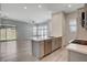 Open kitchen boasts an island, stainless appliances, light countertops, and flows into the living area at 924 Allister Fields Ln, Las Vegas, NV 89138