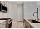 Modern kitchen featuring stainless steel appliances, a gas range, light wood floors, and light countertops at 924 Allister Fields Ln, Las Vegas, NV 89138