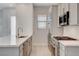 Updated kitchen featuring modern appliances, light wood floors, and light countertops at 924 Allister Fields Ln, Las Vegas, NV 89138