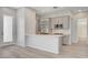 Modern kitchen featuring stainless steel appliances, a breakfast bar, and sleek cabinetry at 924 Allister Fields Ln, Las Vegas, NV 89138