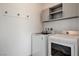 Functional laundry room featuring a washer, a dryer, and upper cabinets for storage at 924 Allister Fields Ln, Las Vegas, NV 89138