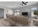Staged living room with hardwood floors, a ceiling fan, and comfortable seating arrangements at 924 Allister Fields Ln, Las Vegas, NV 89138
