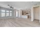 Spacious living room with a ceiling fan and view of the modern kitchen at 924 Allister Fields Ln, Las Vegas, NV 89138