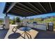 Outdoor kitchen equipped with stainless steel grills, ample counter space, and comfortable seating for al fresco dining at 924 Allister Fields Ln, Las Vegas, NV 89138