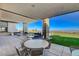Expansive outdoor patio area perfect for entertaining, with comfortable seating, a lush lawn, and panoramic views at 924 Allister Fields Ln, Las Vegas, NV 89138