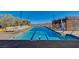 A pristine community pool on a sunny day invites relaxation and recreation with comfortable lounge chairs nearby at 924 Allister Fields Ln, Las Vegas, NV 89138