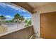 Balcony with palm tree views and a door to the residence on a sunny day at 9303 Gilcrease Ave # 2198, Las Vegas, NV 89149