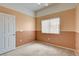 Bright bedroom featuring neutral carpet, a ceiling fan, and a large window for ample natural light at 9303 Gilcrease Ave # 2198, Las Vegas, NV 89149