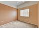 Well-lit bedroom featuring neutral carpet, a ceiling fan, and a large window at 9303 Gilcrease Ave # 2198, Las Vegas, NV 89149