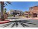 Gated community entrance with stone pillars and lush landscaping at 9303 Gilcrease Ave # 2198, Las Vegas, NV 89149
