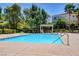 A refreshing community pool with lounge chairs and lush greenery for residents to enjoy at 9303 Gilcrease Ave # 2198, Las Vegas, NV 89149
