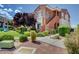 Exterior of a townhome with well-maintained landscaping, a nearby playground, and ample parking at 9303 Gilcrease Ave # 2198, Las Vegas, NV 89149