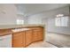 Kitchen with wood cabinets, countertop, sink and view into living space at 9303 Gilcrease Ave # 2198, Las Vegas, NV 89149