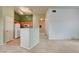 Open concept featuring a half wall into the kitchen with white appliances and wood cabinets at 9303 Gilcrease Ave # 2198, Las Vegas, NV 89149