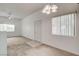 Open concept living room featuring carpet, large windows, and modern lighting at 9303 Gilcrease Ave # 2198, Las Vegas, NV 89149