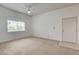 Spacious living room featuring neutral carpet, a ceiling fan, and a bright window at 9303 Gilcrease Ave # 2198, Las Vegas, NV 89149