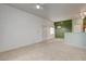 Open floor plan with carpeted floors, white walls and green accent wall, and a ceiling fan at 9303 Gilcrease Ave # 2198, Las Vegas, NV 89149