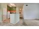 Open-concept living room with carpet and a half-wall overlooking the kitchen with tile flooring at 9303 Gilcrease Ave # 2198, Las Vegas, NV 89149