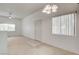 View of empty living room featuring neutral carpet, white walls, and bright natural light at 9303 Gilcrease Ave # 2198, Las Vegas, NV 89149