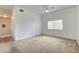 Spacious carpeted living room with a ceiling fan, large window, and access to hallway at 9303 Gilcrease Ave # 2198, Las Vegas, NV 89149