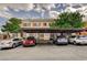 Exterior view of the complex with covered parking spaces and multiple cars parked underneath at 9303 Gilcrease Ave # 2198, Las Vegas, NV 89149
