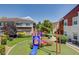 A well-maintained playground featuring a slide and climbing structures, surrounded by lush landscaping in the community at 9303 Gilcrease Ave # 2198, Las Vegas, NV 89149
