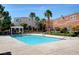 Community pool with refreshing blue water, palm trees and ample space for lounge chairs at 9303 Gilcrease Ave # 2198, Las Vegas, NV 89149