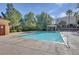 Community pool with clear water, pergola, and lush landscaping on a sunny day at 9303 Gilcrease Ave # 2198, Las Vegas, NV 89149