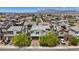 Suburban homes with mountain backdrop, featuring mature landscaping and architectural variety at 9710 Hiking Ave, Las Vegas, NV 89166