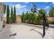 Backyard court area featuring basketball hoop, desert landscaping, and privacy wall at 9710 Hiking Ave, Las Vegas, NV 89166