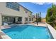 Home's backyard oasis featuring a large pool, hot tub, basketball court, landscaping and patio at 9710 Hiking Ave, Las Vegas, NV 89166