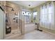 Bathroom featuring a tub, tiled shower, and bright natural lighting at 9710 Hiking Ave, Las Vegas, NV 89166