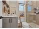 Well-lit bathroom featuring a walk-in shower, modern vanity, and convenient storage shelves at 9710 Hiking Ave, Las Vegas, NV 89166