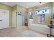Bathroom showcasing a tub, tiled shower, and well-lit vanity area at 9710 Hiking Ave, Las Vegas, NV 89166