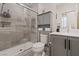 Modern bathroom featuring a tiled shower with glass door and gray vanity at 9710 Hiking Ave, Las Vegas, NV 89166