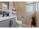 Stylish half-bathroom featuring modern fixtures, a gray vanity, and neutral walls at 9710 Hiking Ave, Las Vegas, NV 89166