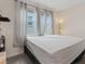 Bright bedroom with a large window, cozy carpeting, and neutral-toned decor at 9710 Hiking Ave, Las Vegas, NV 89166