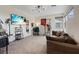 Comfortable bonus room with a sofa, television, and workout equipment, offering versatile recreational space at 9710 Hiking Ave, Las Vegas, NV 89166