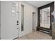 Modern foyer with wood-look tile flooring, a bench, and a decorative mirror at 9710 Hiking Ave, Las Vegas, NV 89166