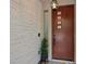 Contemporary front entrance with a unique light fixture and decorative stone wall detail at 9710 Hiking Ave, Las Vegas, NV 89166