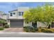Inviting two-story home with desert landscaping, a stone accent wall, and a spacious garage at 9710 Hiking Ave, Las Vegas, NV 89166